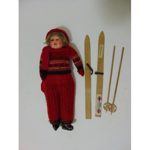 75 - Early 20th century celluloid shoulder head doll with blue closing eyes and cloth body wearing knitte... 