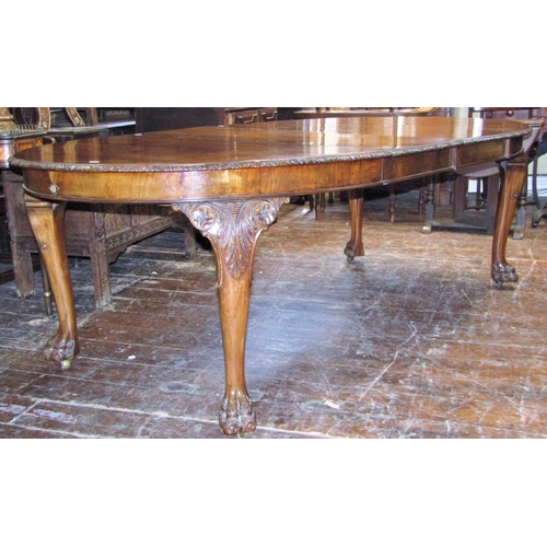 2805 - A good quality walnut D end extending dining table enclosing two additional leaves with carved and f... 