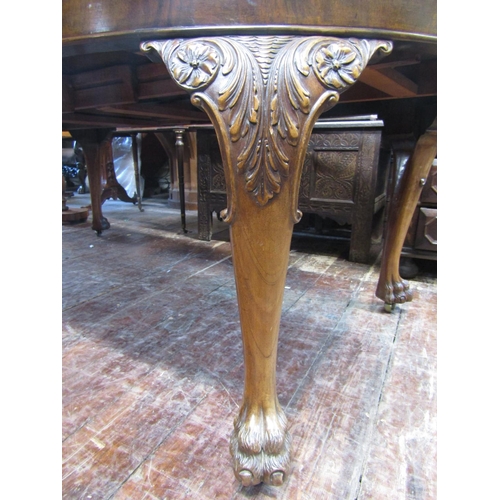 2805 - A good quality walnut D end extending dining table enclosing two additional leaves with carved and f... 