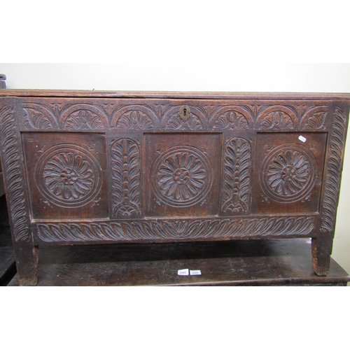 2811 - 18th century oak coffer, the front elevation with sunburst and foliate detail, set beneath a plank t... 