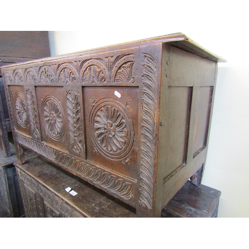 2811 - 18th century oak coffer, the front elevation with sunburst and foliate detail, set beneath a plank t... 