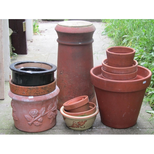 2077 - A reclaimed and partially later infilled terracotta cylindrical chimney pot, 58cm high, together wit... 