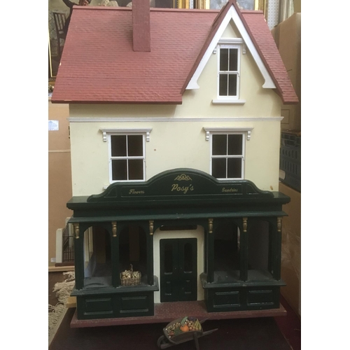 80 - Large dolls house with attractive flower shop frontage, interior is largely unfurnished and undecora... 