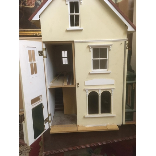 80 - Large dolls house with attractive flower shop frontage, interior is largely unfurnished and undecora... 