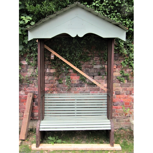 2088 - A home built garden arbor and combined slatted bench seat, flanked by glazed side panels beneath an ... 