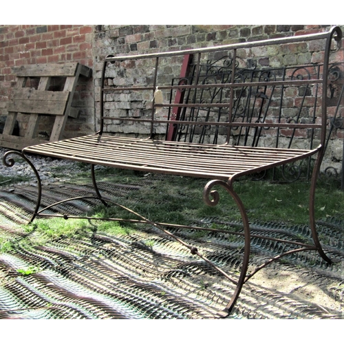 2115 - A weathered Regency style iron work three seat garden bench with strapwork seat and scrolled back, r... 