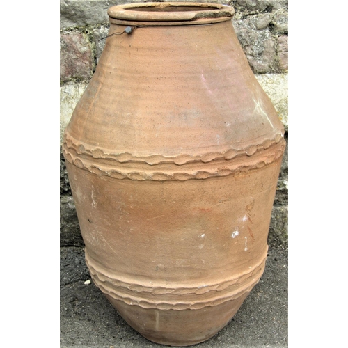 2153 - A terracotta oviform jar with repeating impressed banded detail, 66cm high