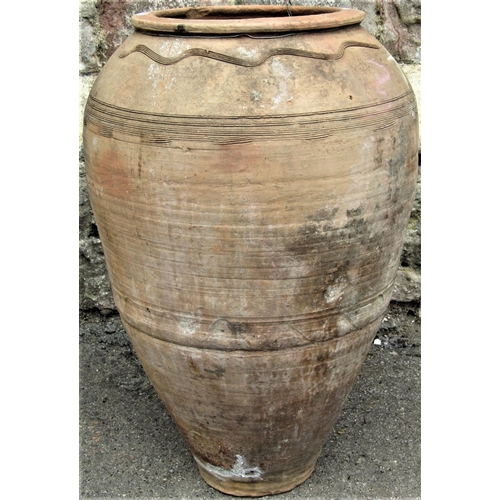 2159 - A buff coloured terracotta oviform tapered vase with wiggle work incised and banded detail, 60cm hig... 