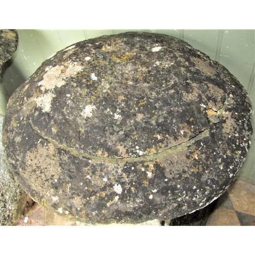 2169 - A weathered natural stone staddlestone of usual square tapered form with domed cap, 80cm high approx... 