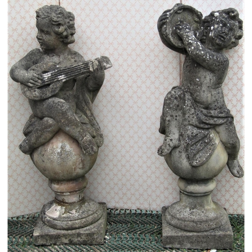 2205 - A pair of large reclaimed putti musicians, one playing the lute the other cymbals, classically drape... 