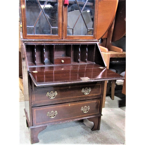 2314 - An inlaid Edwardian mahogany bureau bookcase, the upper section enclosed by a pair of astragal glaze... 