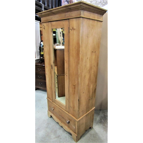 2327 - A Victorian stripped pine single wardrobe with fixed moulded cornice over a central three quarter le... 