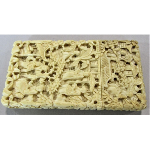 1547 - A canton ivory card case with typical carved decoration of figures in a pagoda landscape, 9 x 5cm