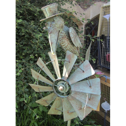 2106 - A contemporary light steel novelty garden wind generator, the finial in the form of a bird wearing a... 