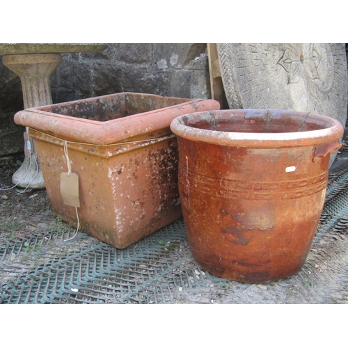 2121 - A weathered terracotta planter of square tapered form with moulded rim, 52 cm square x 41 cm high, t... 