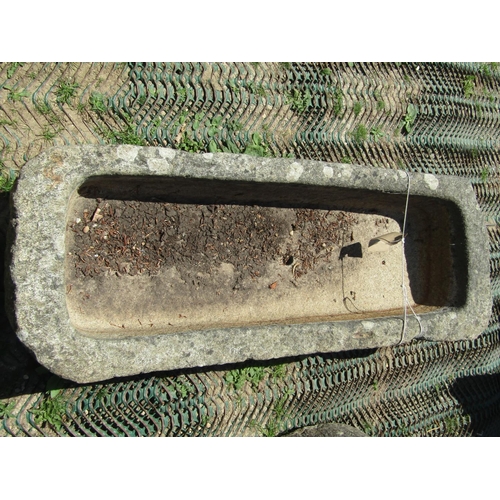 2131 - A weathered granite trough of rectangular form with rounded corners and single drainage hole, 121 cm... 