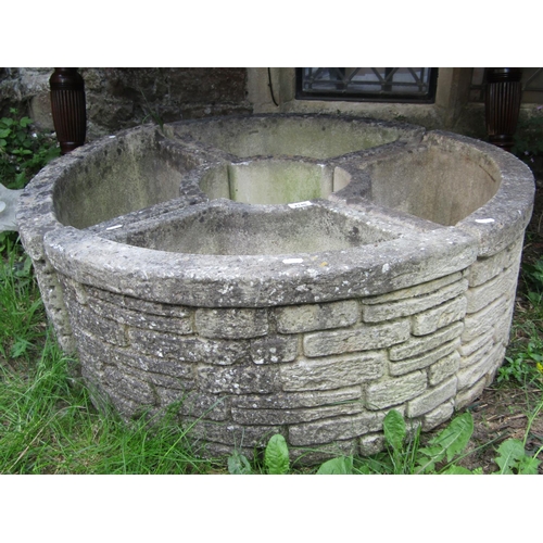 2140 - Four reclaimed garden planters of crescent form with simulated stone wall façade, when together form... 