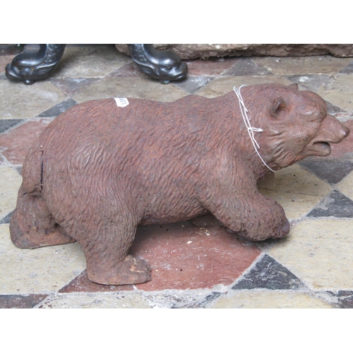 2157 - A filled and weathered cast iron ornament in the form of a standing bear approx 40cm long x 18cm hig... 