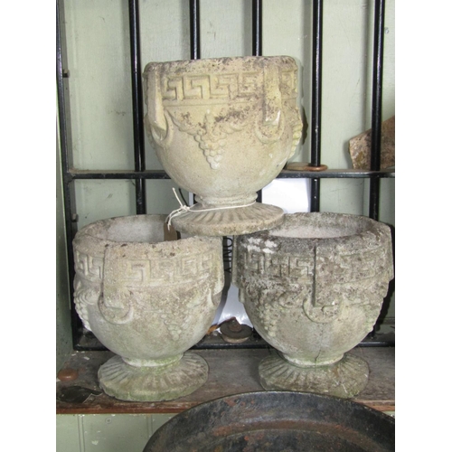 2179 - A set of three small reclaimed garden urns, of circular waisted form with ring, Greek key and repeat... 