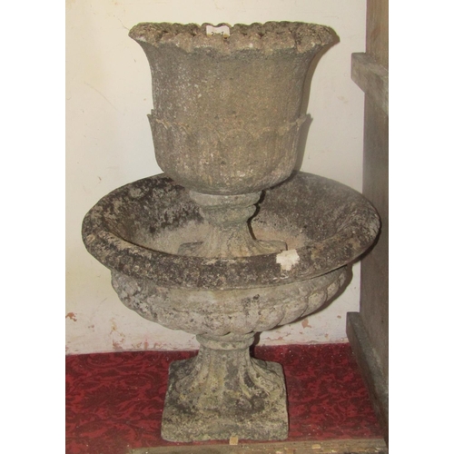 2227 - A small reclaimed garden urn of circular form with foliate detail and fluted socle, together with on... 