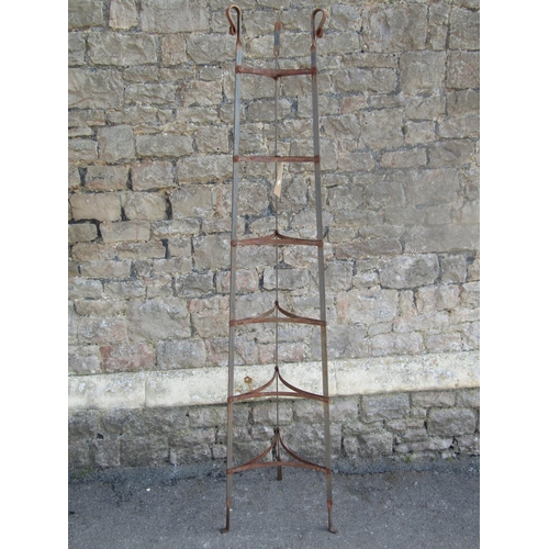 2231 - A vintage floorstanding graduated six tier iron strap work saucepan stand with simple twisted and sc... 