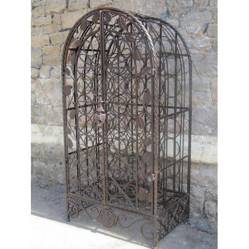 2237 - A contemporary metal strapwork wine cage of arched form, enclosed by a pair of doors with decorative... 