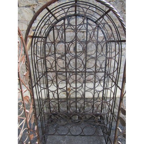 2237 - A contemporary metal strapwork wine cage of arched form, enclosed by a pair of doors with decorative... 