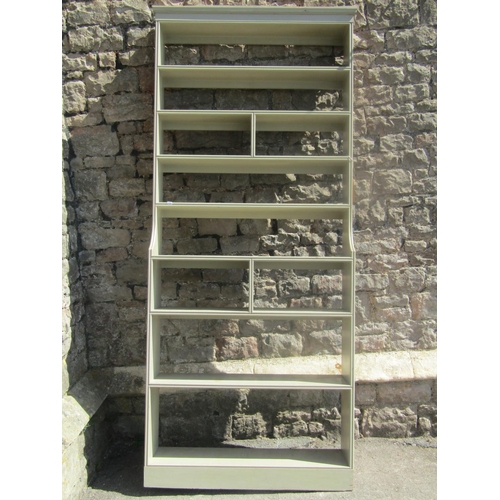 2238 - A freestanding light green painted pine bookcase/shelving unit, with fixed and segmented shelves wit... 