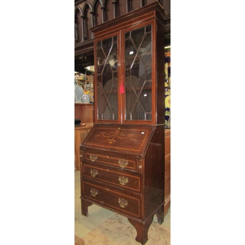 2314 - An inlaid Edwardian mahogany bureau bookcase, the upper section enclosed by a pair of astragal glaze... 