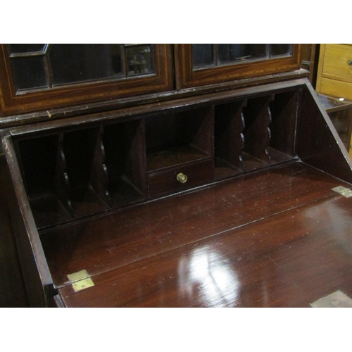 2314 - An inlaid Edwardian mahogany bureau bookcase, the upper section enclosed by a pair of astragal glaze... 