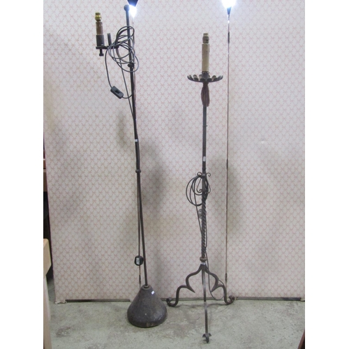 2321 - An old English style ironwork standard lamp together with one other in the gothic manner (2)