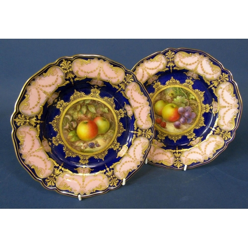 1062 - A pair of Royal Worcester cabinet plates with central fruit panels signed R Sebright within pink and... 