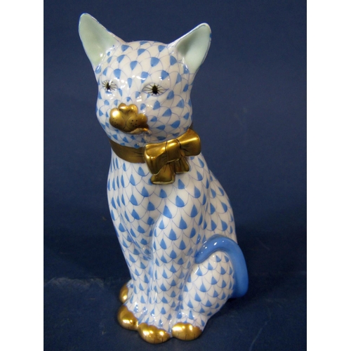 1076 - A Herend model of a seated cat with blue and white painted decoration and gilt bow, 12cm tall approx