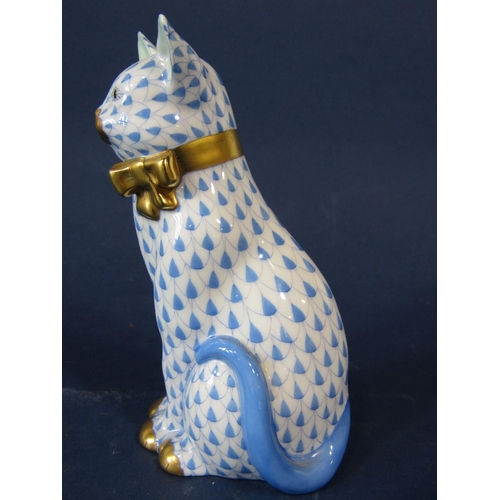 1076 - A Herend model of a seated cat with blue and white painted decoration and gilt bow, 12cm tall approx