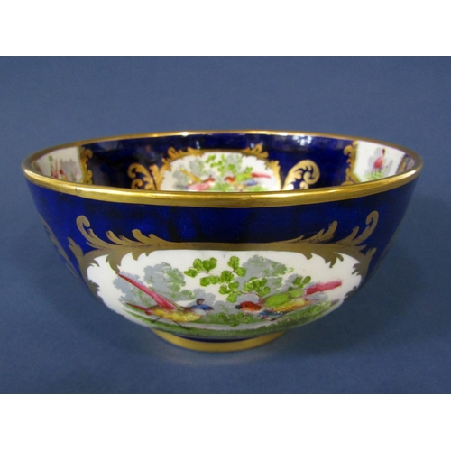 1090 - A late 19th century continental bowl of elongated oval form with applied fruit swag, painted floral ... 