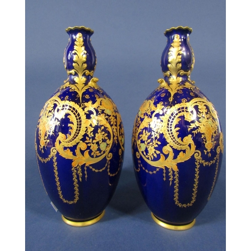 1092 - A pair of Royal Crown Derby blue ground vases with gilt scrolling and swag decoration, with green pr... 