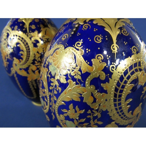 1092 - A pair of Royal Crown Derby blue ground vases with gilt scrolling and swag decoration, with green pr... 