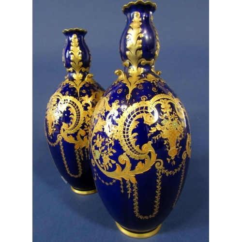 1092 - A pair of Royal Crown Derby blue ground vases with gilt scrolling and swag decoration, with green pr... 