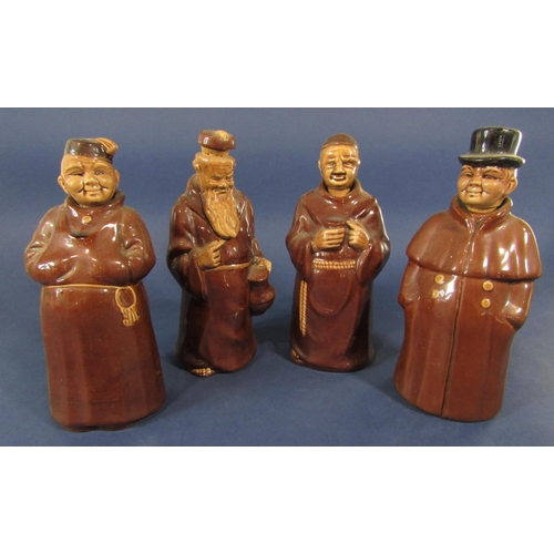 1116 - A set of four brown glazed decanters and stoppers in the form of oriental characters, a monk and a c... 