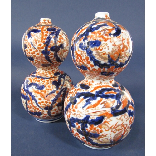 1120 - A pair of late 19th century Imari vases of double gourd shaped form, 26 cm tall approximately