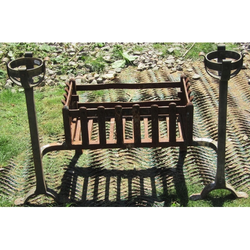 2101 - Two similar old iron work trestles together with a cast iron fire basket with circular basket shaped... 