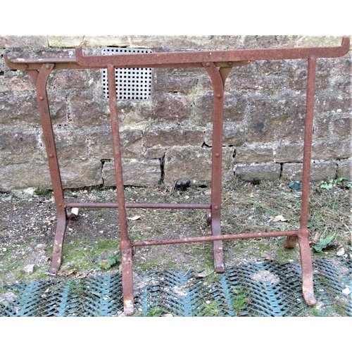 2101 - Two similar old iron work trestles together with a cast iron fire basket with circular basket shaped... 