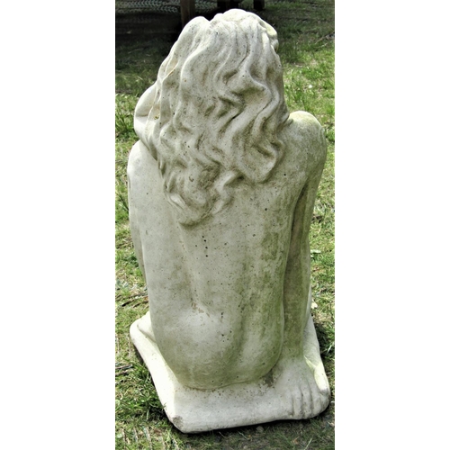 2119 - A reclaimed garden figure in the form of a female nude in seated pose with long flowing hair, 66 cm ... 