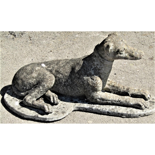 2148 - A well weathered reclaimed garden ornament in the form of a recumbent whippet with shaped platform b... 