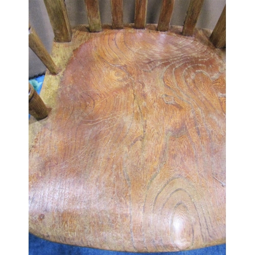 2284 - A Windsor elm and beechwood lathe back arm chair with wide generous saddle shaped seat raised on spl... 