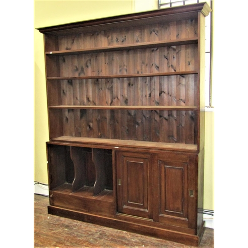 2777 - A mahogany library bookcase of full height, the lower section enclosed by two sliding doors with pan... 