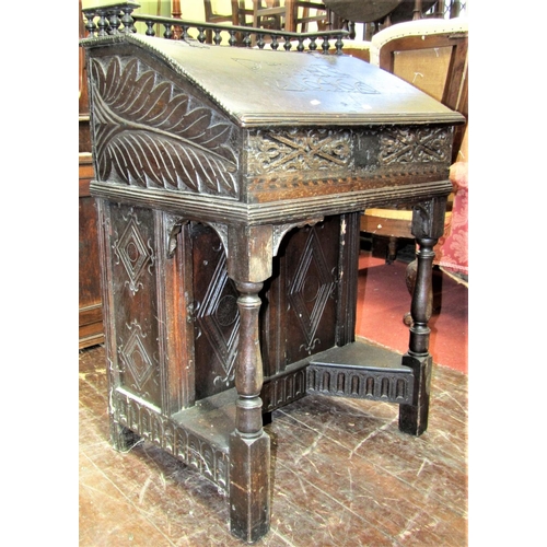 2792 - An Old English oak writing desk, the sloping lid monogrammed and dated 1646, set beneath a turned sp... 