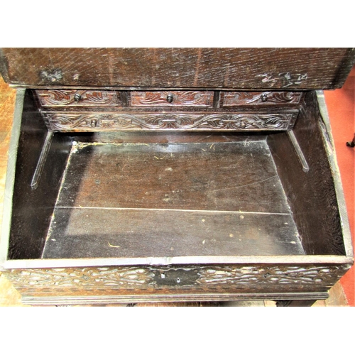 2792 - An Old English oak writing desk, the sloping lid monogrammed and dated 1646, set beneath a turned sp... 