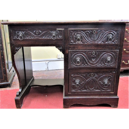 2793 - A late 19th century oak single pedestal writing desk fitted with four drawers with carved outline, w... 