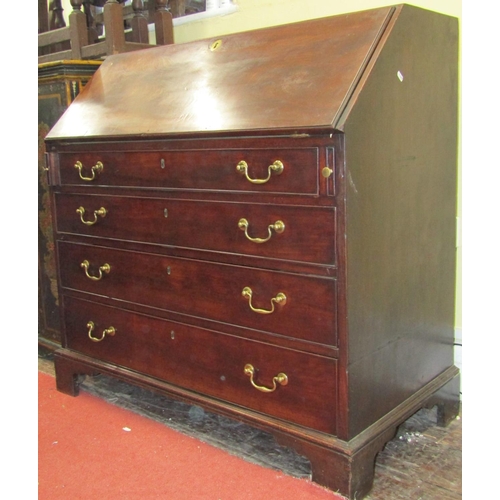 2795 - A Georgian mahogany writing bureau of four long graduated drawers, the fall flap enclosing a fitted ... 